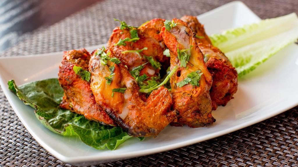 Tandoori Chicken Wings · Chicken wings marinated in spiced yogurt and grilled in tandoor oven, served with house chutney.