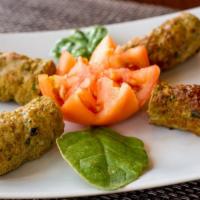 Seekh Kebab · Minced lamb seasoned with Indian herbs rolled on a skewer and broiled in clay oven.