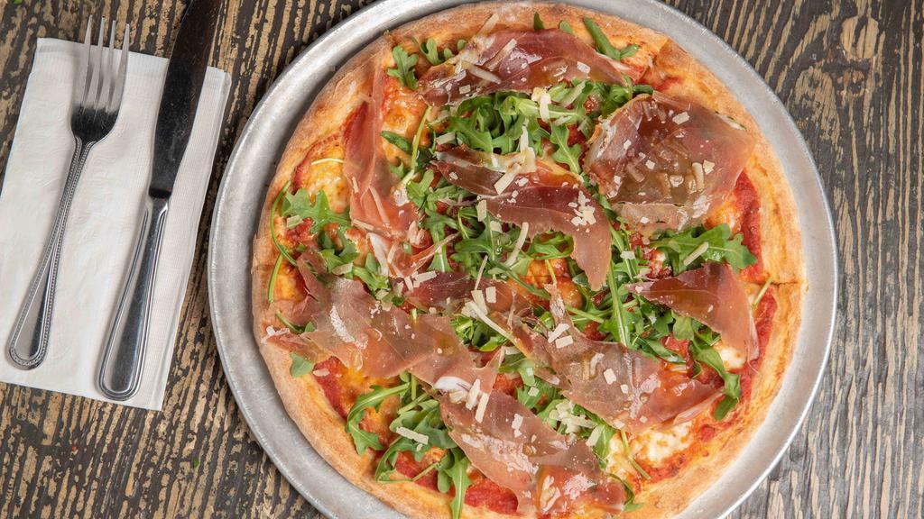 Prosciutto Pizza · Tomato sauce, fresh mozzarella, arugula, prosciutto di Parma and shaved parmigiano.