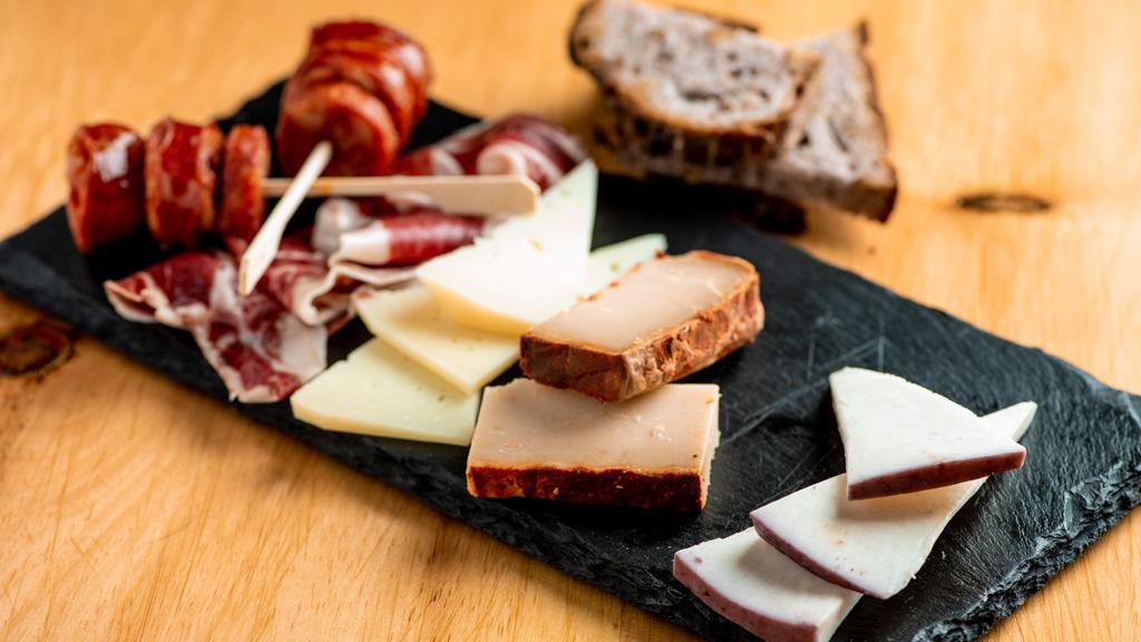 Tabla De Quesos · Cheese plate. Manchego, majorero, mahon, roncal quince paste, served with walnut bread, mixed olives.