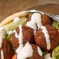 Falafel · Served on a pita bread with salad along with Hot and White sauce.