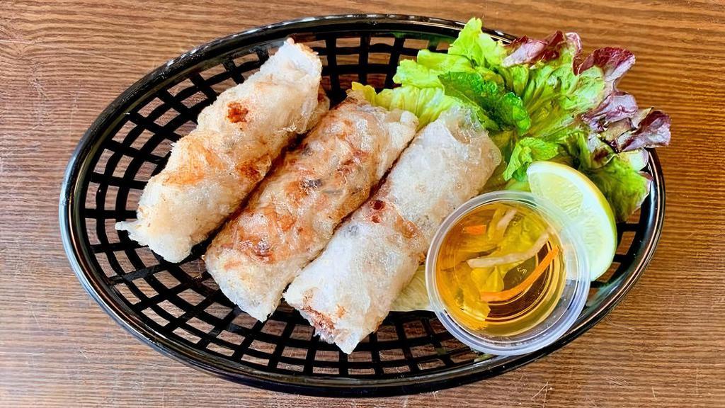 Crispy Spring Rolls · (3pcs) Deep fried homemade rice paper rolls. made with pork, scallions, taro, carrots, mushrooms. Served with lettuce wrap and vinaigrette fish sauce. ( Gluten free )