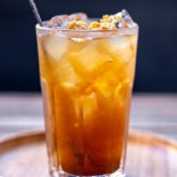 Tamarind Juice · Homemade tamarind juice. A drink that packs a tart and sweet punch. Served with crushed pean...