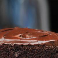 Gourmet Triple Chocolate Cake Slice With Whip Cream · Chocolate cake filled with chocolate cream, hazelnut cream and hazelnut crunch, finished wit...