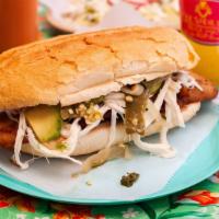 Torta De Milanesa De Pollo · Mexican style bread chicken sandwich. Filled with melted queso Oaxaca, refried beans, avocad...
