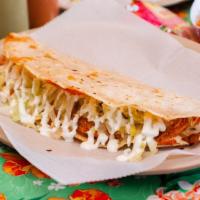 Quesadilla De Al Pastor · Quesadilla filled with grilled spicy pork served with queso Oaxaca, lettuce, sour cream and ...