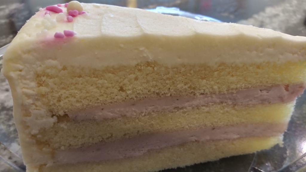 White Raspberry Torte · Cheesy Eddie's famous white chiffon cake layered with raspberry mousse filling and frosted with cream cheese frosting