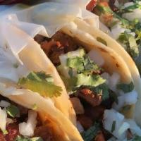Order Of 3 Shredded Chicken Tacos  · on a corn tortilla with onions and cilantro
shredded chicken is cooked with tomatoes and oni...
