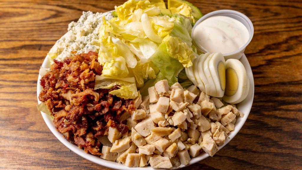 Cobb Salad · Romaine, Marinated baked chicken, crispy bacon, tomatoes, hard-boiled egg, avocado, and crumbled blue cheese with Blue cheese dressing.