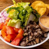 Southwest Flank Steak Salad · Romaine, marinated flank steak, red onions, corn, black beans, tortilla strips, and tomatoes...