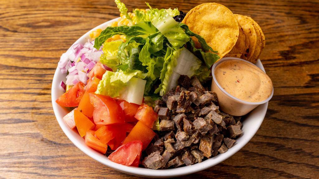 Southwest Flank Steak Salad · Romaine, marinated flank steak, red onions, corn, black beans, tortilla strips, and tomatoes with Chipotle cheddar dressing.