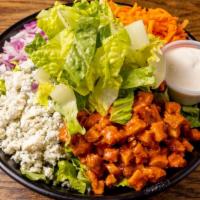 Buffalo Salad · Romaine, Crispy buffalo chicken, red onions, shredded carrots, celery, and blue cheese with ...