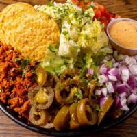 Chorizo Taco Salad · Iceberg lettuce, chorizo, tomatoes,  jalapeños, tortilla strips, cilantro, corn and red onio...
