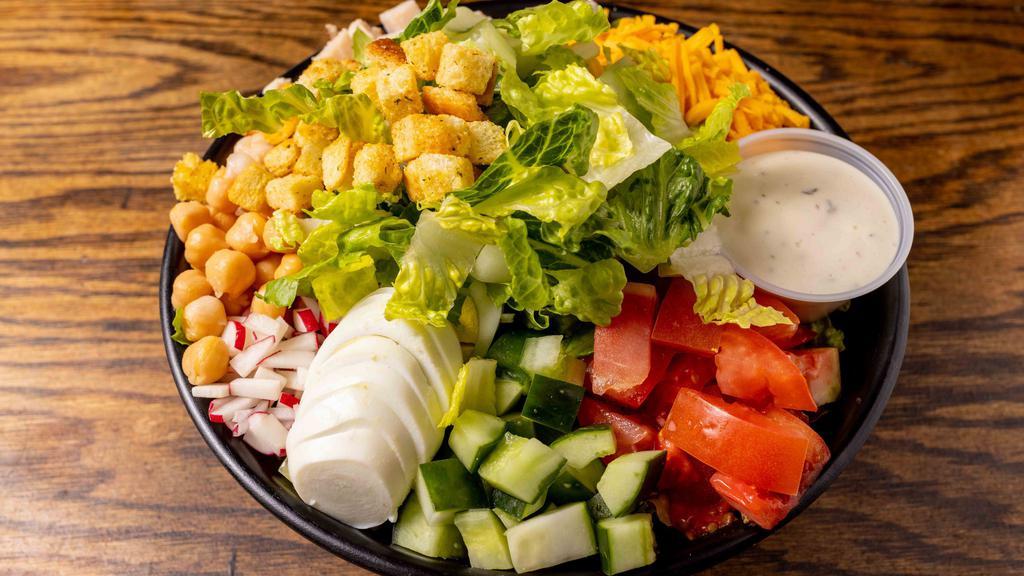 Chef Salad · Iceberg, turkey, tomatoes, chickpeas, hard-boiled egg, cucumber, radishes, and croutons.