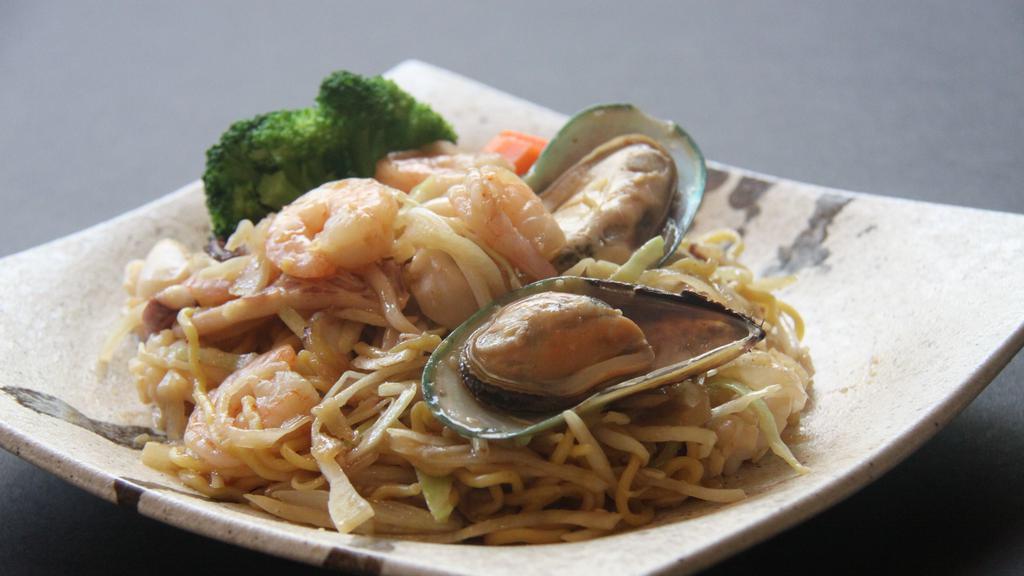 Seafood Yaki Ramen · Spicy pan-fried seafood noodles with our homemade soy sauce and vegetables. Topped with shrimp, squid, mussel, cabbage, onion, bean sprouts, and carrot. No broth.