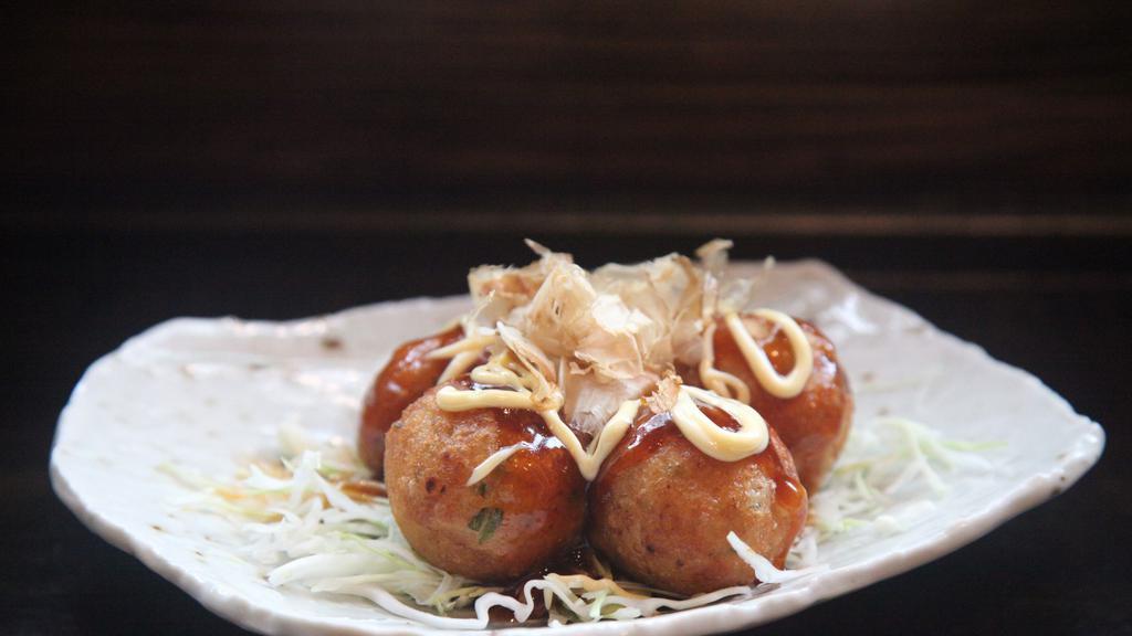 Takoyaki · Ball-shaped Japanese snack made with a wheat flour-based batter and filled with minced octopus. Topped with takoyaki sauce, mayonnaise and dried shaved bonito.