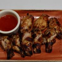 Grilled Buffalo Wings · (fresh organic marinated chicken wings, grilled & sauced) 
(Choice of sauces: Honey BBQ, Swe...