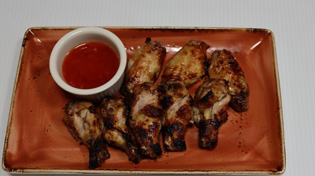 Grilled Buffalo Wings · (fresh organic marinated chicken wings, grilled & sauced) 
(Choice of sauces: Honey BBQ, Sweet & Sour, or Plain).
