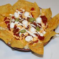 Nachos · (crispy corn tortillas chips, topped with beef, mexican cheese, 
salsa con queso, salsa, sou...