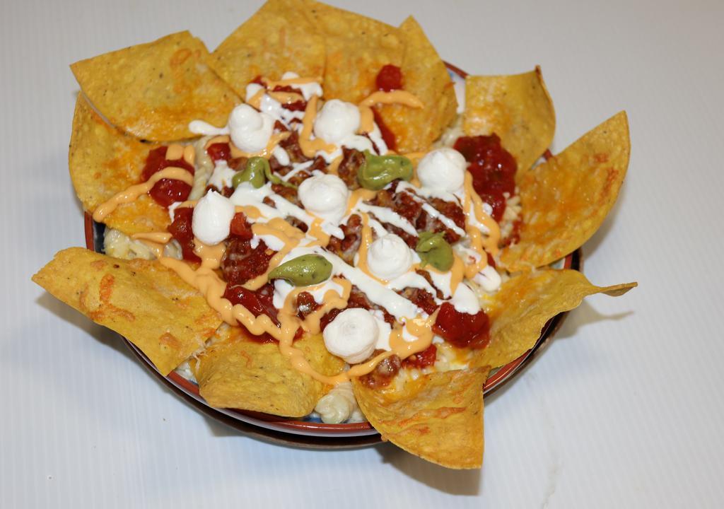 Nachos · (crispy corn tortillas chips, topped with beef, mexican cheese, 
salsa con queso, salsa, sour cream, and guacamole).