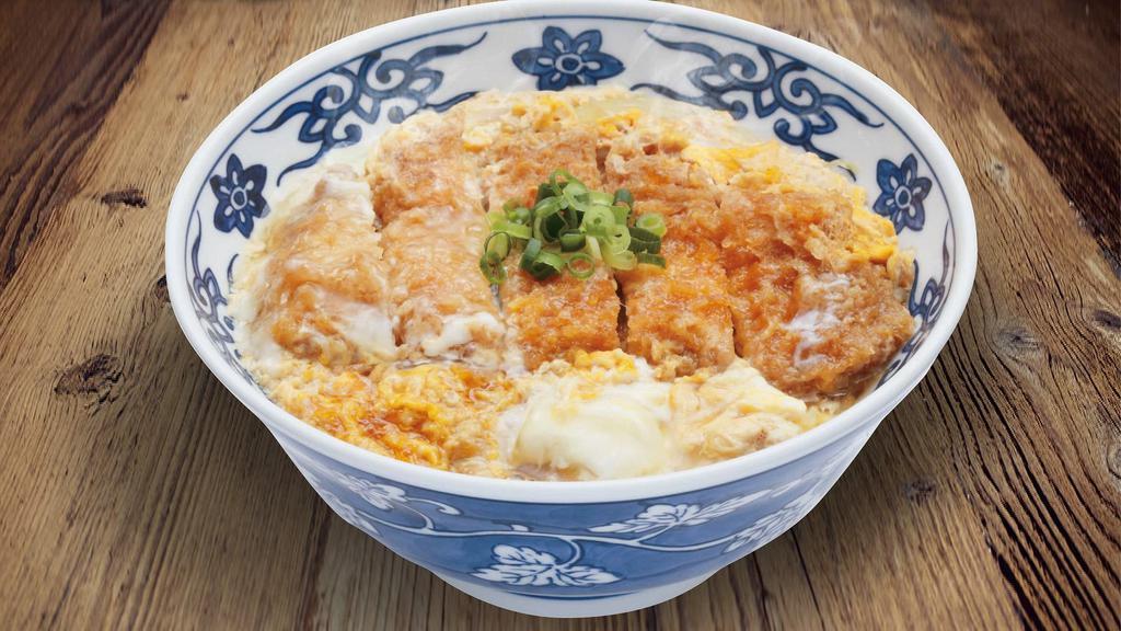 Katsu Don · Bowl of rice topped with deep fried pork cutlet simmered in umami-dashi based broth with miso soup,onions and eggs.