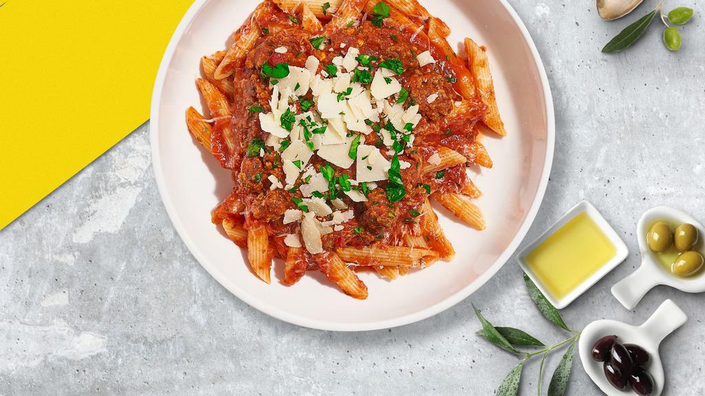 Bluffing Bolognese Pasta (Vegan Penne) · Fresh penne pasta cooked in a meaty bolognese sauce and topped with black pepper, parsley, and parmesan.