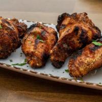 Mera Wings · Char-grilled chicken, homemade harissa sauce.
