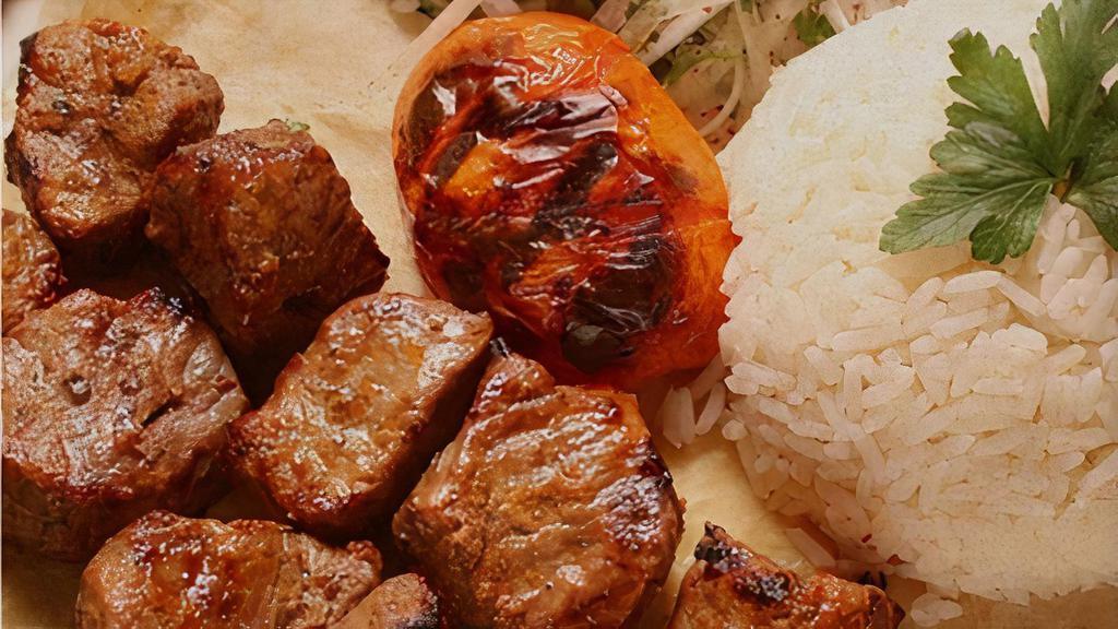 Kebab Plate · Tender chunks of either chicken or lamb meat marinated in chefs special sauce served over rice and salad.