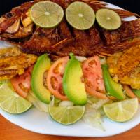 Mojarra Frita / Fried Fish · Tostones, Arroz, y Ensalada de Lechuga y Tomate. / Green plantains, Rice, Lettuce & Tomato S...