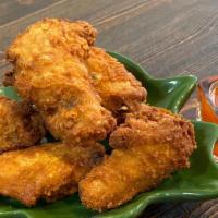 Thai Wings · Spicy. Most popular. Fried chicken wings served with Thai sweet chili sauce.