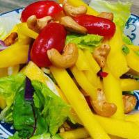 Mango Salad · Spicy. Shredded mango tossed with red onion, scallion, mint, and cashew nuts, with chili-lim...
