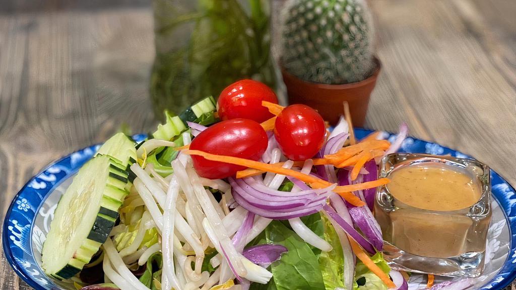 Thai Green Salad · Mixed greens, lettuce, tomatoes, cucumber, carrots, and beansprouts with peanut dressing.