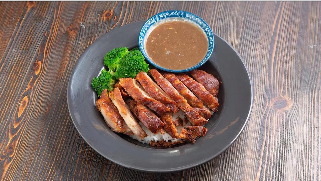 Crispy Duck Over Rice · Crispy boneless duck served with steamed broccoli and brown gravy sauce.