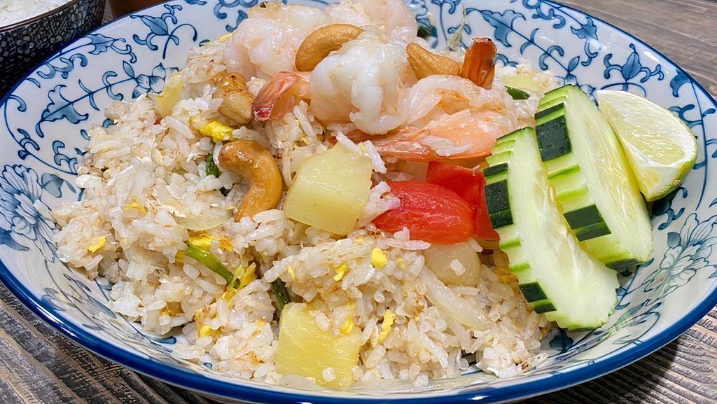 Pineapple Fried Rice · Fried rice with egg, cashew nut, pineapple, onion, scallion, and tomatoes.