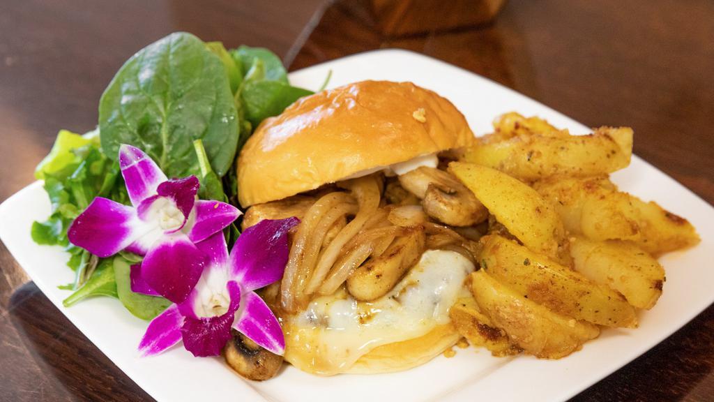 Wagyu Beef Burger · Wagyu beef burger (well-done), mushrooms, onions, provolone, on a housemade bun served with rosemary garlic potatoes, and a side salad.