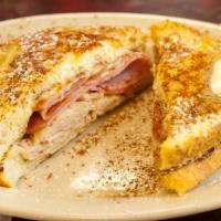 Monte Cristo · A grilled ham, turkey, and cheese sandwich on the inside and French toast on the outside, to...