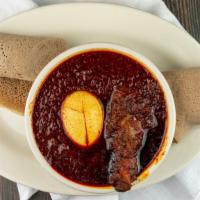 Doro We'T · Chicken cooked and perfectly simmered with seasoned berbere sauce with hard-boiled egg.