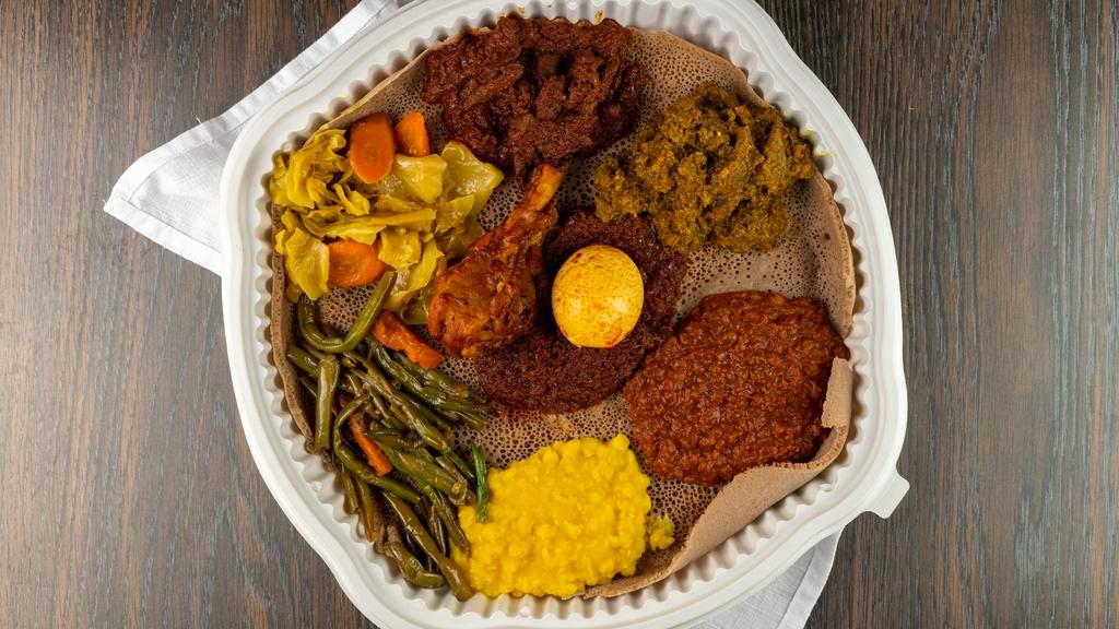 Addis Special · Chicken, beef, lamb and choice of your own four vegetable sides. You can choose from: cabbage, collard greens, lentils, green beans, potato stew, and split lentils.