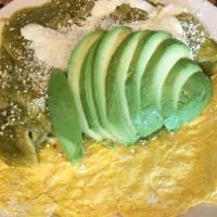 Chilaquiles · Three scrambled eggs, served with sauteed corn tortillas with salsa verde or roja, sour crea...