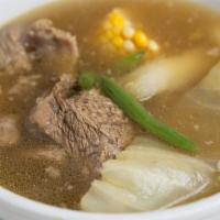Sopa De Res · Home style beef soup with cabbage, yuca, corn on the cob and string beans, served with rice.