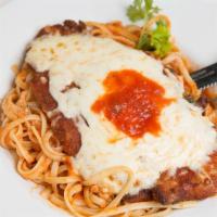 Chicken Parmagiana · Breaded chicken cutlet, topped with melted mozzarella cheese, served over linguini with fres...