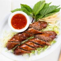 Thai Sausage · Ground pork, red onion, lime leaf, black pepper, salt sugar, red pepper, and fish sauce. Ser...