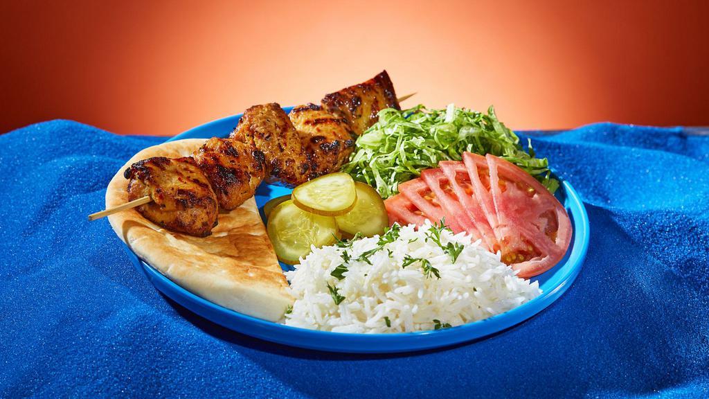 Grilled Chicken Kebab Platter · Marinated cubes of chicken grilled on a skewer. Served with rice or hummus, lettuce, tomato, pickles, and pita.