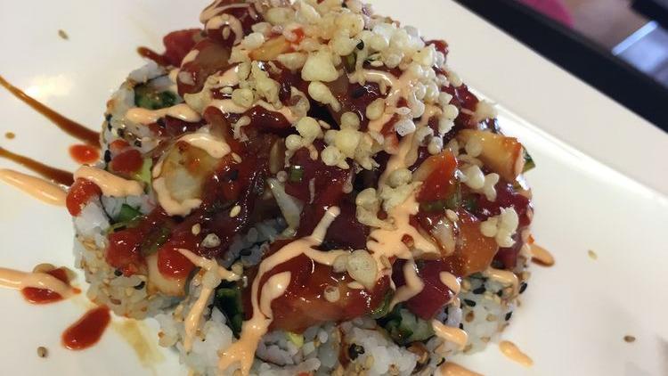 Volcano Roll · Crab, cucumber, avocado topped with fish medley, masago, scallion & our special sauce.