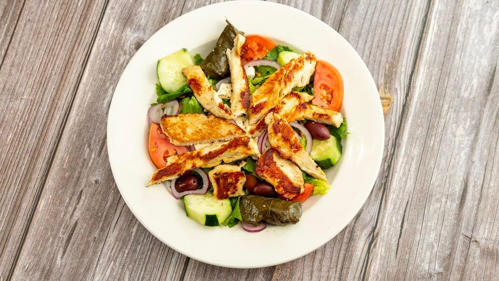 Greek Salad · Romaine lettuce, tomato, cucumbers, anchovies, feta cheese and grape leaves.