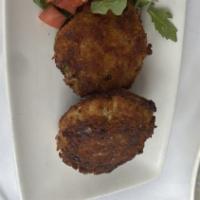 Maryland Crab Cakes · Over an arugula, diced tomato, and onion salad in a lemon tartar sauce.  Comes with House Sa...