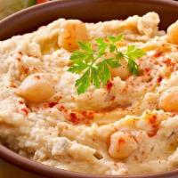 Hummus Large · Hummus is a Middle Eastern dip, spread, or savory dish made from cooked, mashed chickpeas bl...