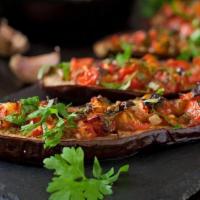 Sauced Eggplant Small · Sauced Eggplant in moderately spicy sauce of fresh tomatoes, green peppers, onions and garlic.