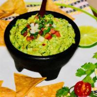 Homemade Guacamole With Nachos ( Chips )  · Guacamole made from the scratch, mixed with diced union, diced tomatoes, cilantro, lime and ...