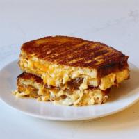 Sweet Cheesus · Cheddar, Gruyere, Parmesan, caramelized onions and spicy aioli on sourdough.
